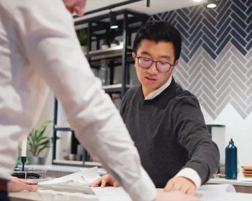 YTL Developments employee pointing at plans on paper