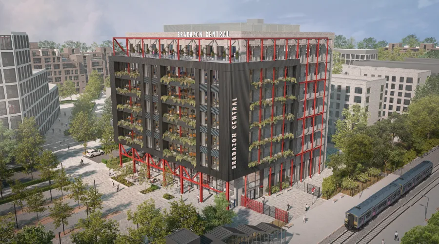 High angle CGI of new, eight-storey  station office building entrance at Brabazon, Bristol, showcasing the new train station, the station square and greenery.