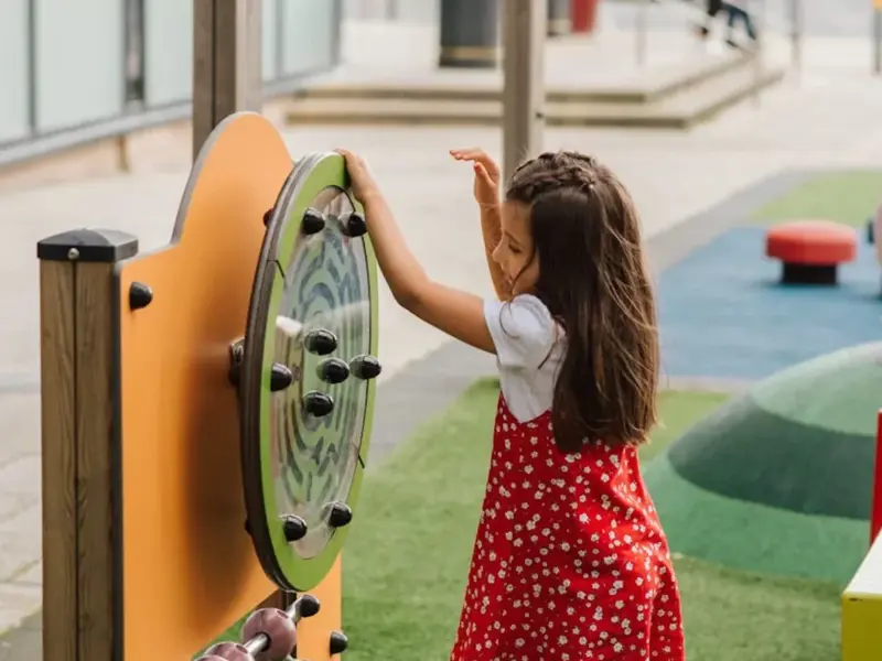 Image of a child playing with park apparatus