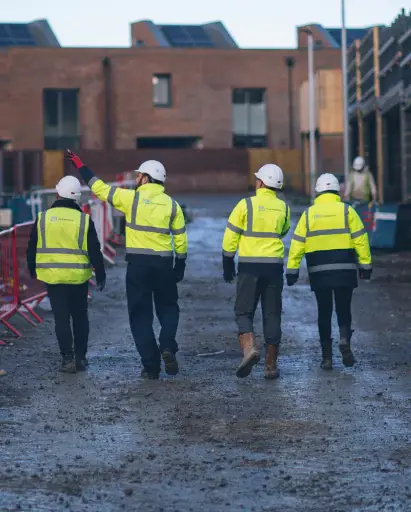 Four YTL Employees walking through a building site